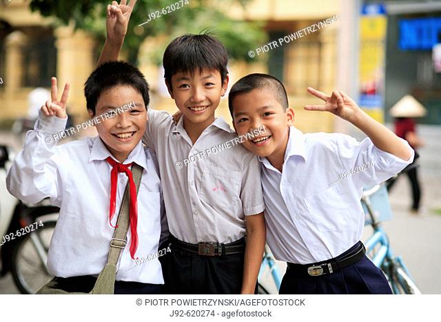 Portrait of three boys showing peace sign. The Old Quarter, Hanoi, Vietnam, Indochina, Southeast Asia, Asia 2006