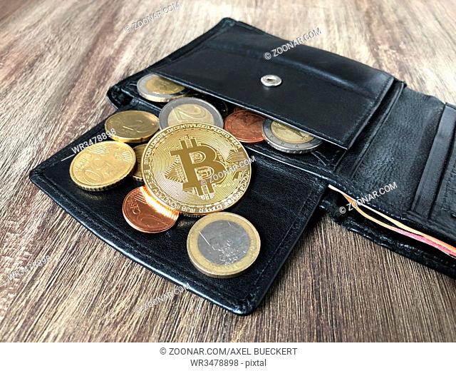black leather wallet with bitcoin euro and cent coins, selective focus, cryptocurrency concept