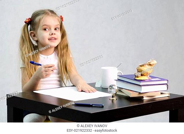 girl happily looks in frame, sitting at table image of writer