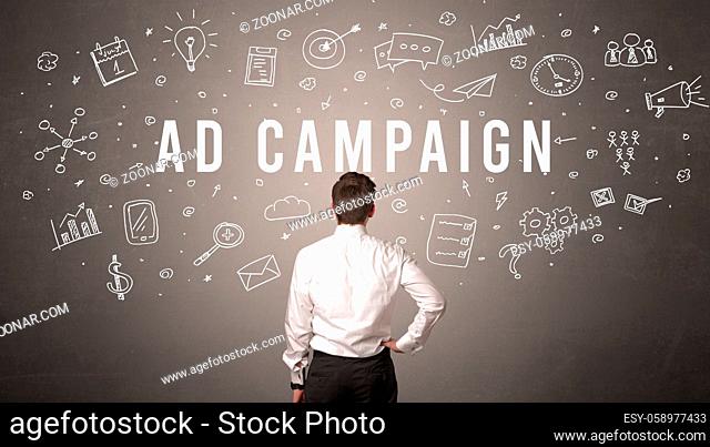Rear view of a businessman with AD CAMPAIGN inscription, modern business concept