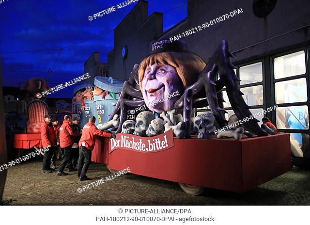 A political caricature float featuring ""German Chancellor Angela Merkel, CDU, as a black widow spider"" is prepared for the Rosenmontag (Shrove...