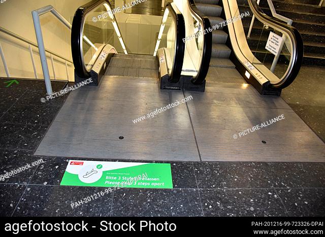 15 December 2020, North Rhine-Westphalia, Cologne: An escalator with the notice 3 steps free at a press event in the ready-to-use Cologne Vaccination Center in...