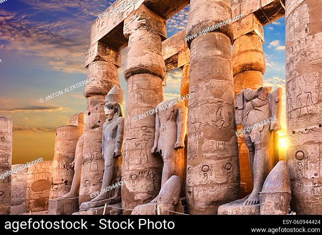 Standing Ramses II statues in Luxor Temple, beautiful sunset view, Egypt
