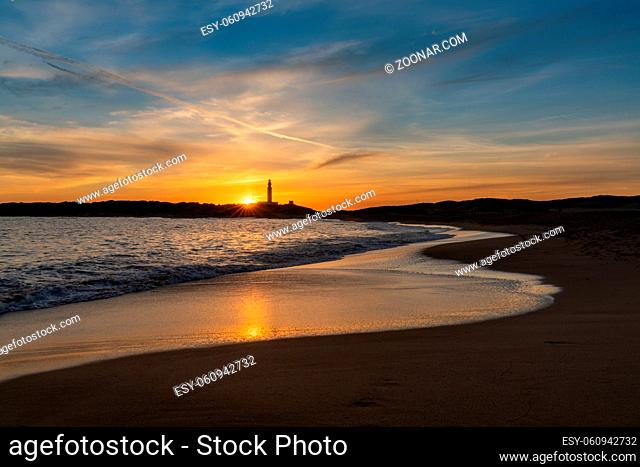 Peaceful sunset on the Playa de Maria Sucia Beach with the Cape Trafalgar Lighthouse in the background