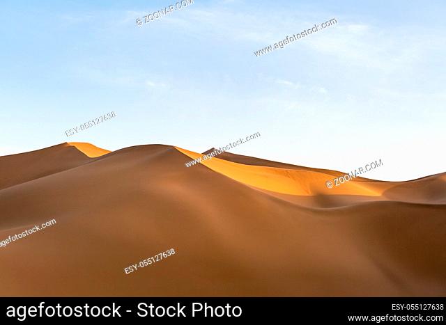 sand dunes illuminated by the setting sun, beautiful desert landscape