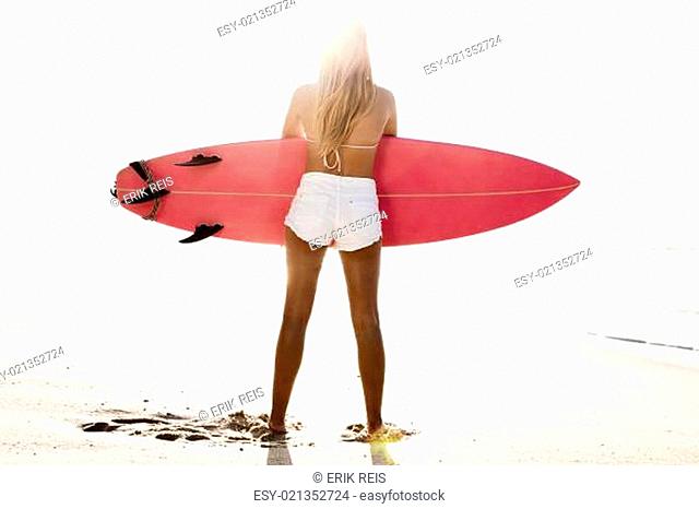 Beautiful female Surfer looking for the waves