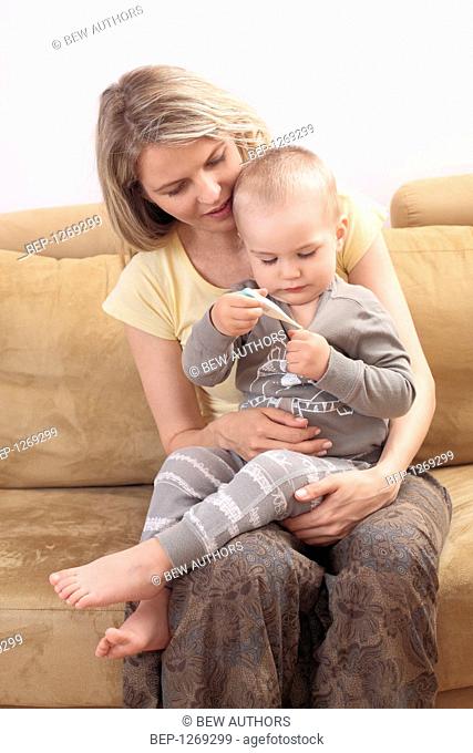 Mother with son measuring temperature