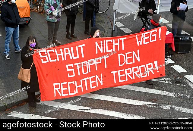 02 December 2021, Baden-Wuerttemberg, Karlsruhe: In front of the Federal Court of Justice (BGH) a banner is held which reads ""DON'T LOOK AWAY! STOP RIGHT-WING...