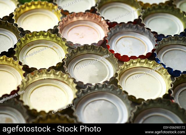 Collection of bottle caps on a stone table