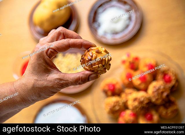 Woman holding sweet food in kitchen