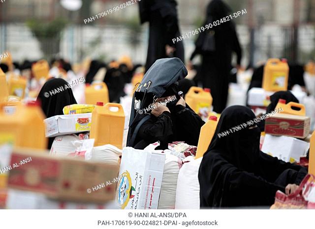 Yemenite women collect an aid donation by the government of Kuwait in Sanaa, Yemen, 19 June 2017. Unabated conflict and rapidly deteriorating conditions across...