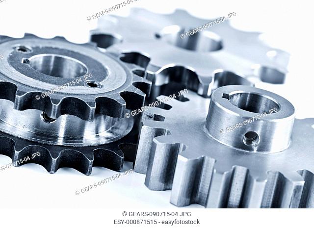 Interlocking industrial metal gears isolated on white
