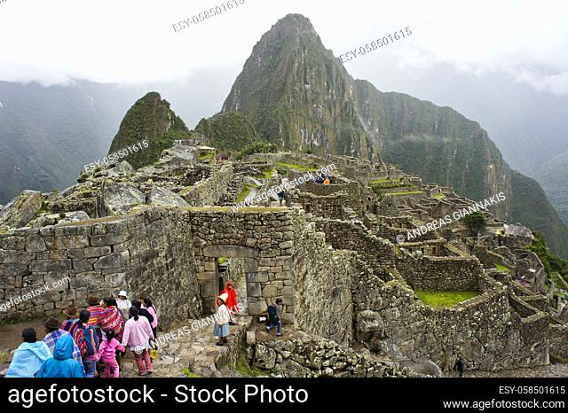 Machu Picchu, Cloudy day, Group of Indians walking, Peru, South America