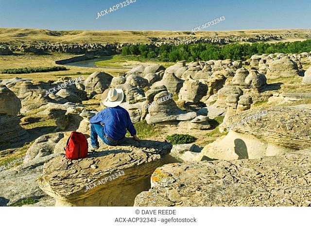 hiker along the Milk River, Writing On Stone Provincial Park, Alberta, Canada