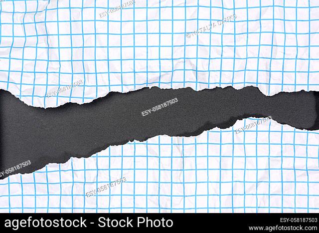 texture of crumpled white paper in a cage, blue lines, torn edges on a black background
