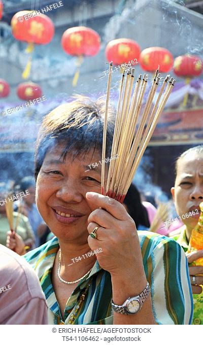 Thai Woman with Incence Sticks in a Temple