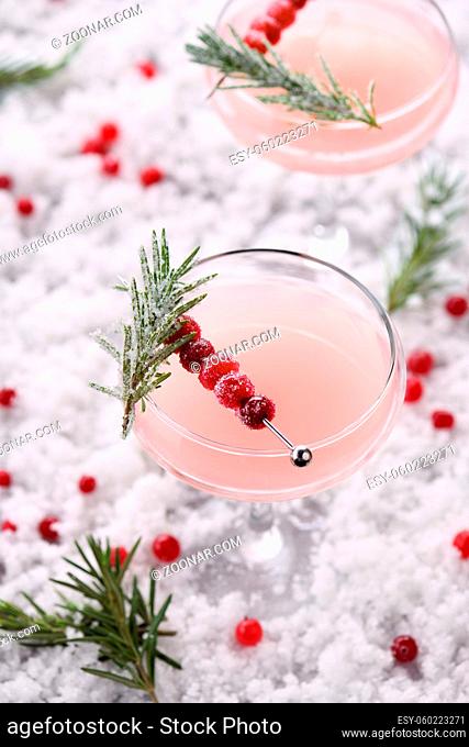 Goblet with cranberry Margarita with candied cranberries, rosemary. Perfect cocktail for a Christmas party