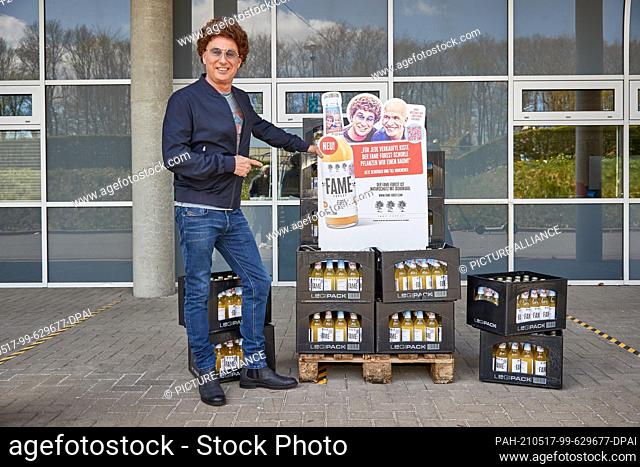 23 April 2021, Hamburg: Atze Schröder, comedian, stands next to bottle crates and an advertising banner of Fame Forest with his likeness and that of Till...