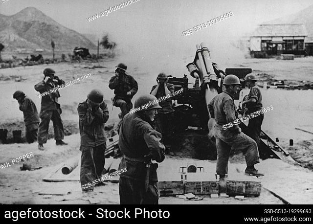 In Action In Korea: Men of a 155mm Howitzer crew hold their ears as their gun goes into action in the fight to push back the North Koreans