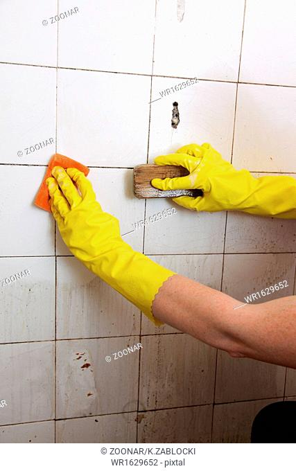 Cleaning of dirty old tiles in a bathroom