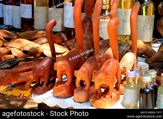 Wooden souvenirs and wines for sale on table stall, Ampangorinana Village, Nosy Komba Island, Madagascar