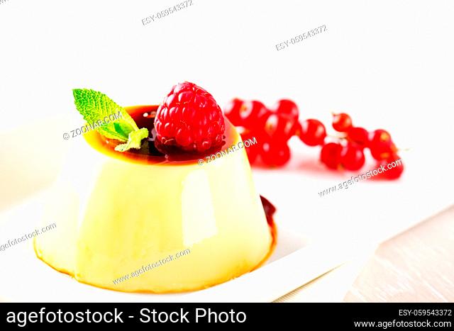 Pudding With Berries and Caramel Sauce. High quality photo