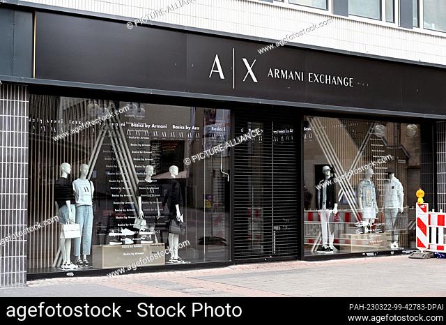 19 March 2023, North Rhine-Westphalia, Cologne: Logo, lettering of the luxury fashion label AX Armani Exchange at a store Photo: Horst Galuschka/dpa