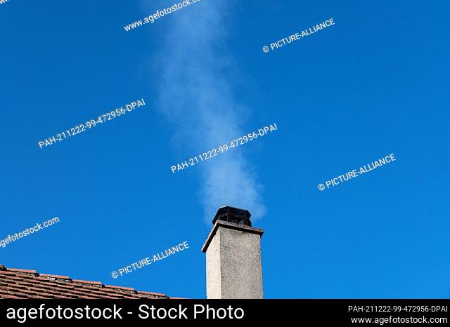 21 December 2021, Baden-Wuerttemberg, Rottweil: White smoke rises from a chimney of an apartment building. Photo: Silas Stein/dpa