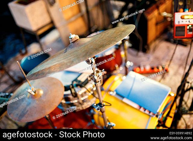 Close-up of a drum cymbal in a drum kit on a blurred background of musical instruments. High quality photo