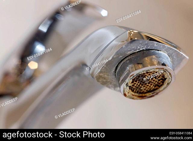Limescale on faucet mesh in bathrooms. Close up view