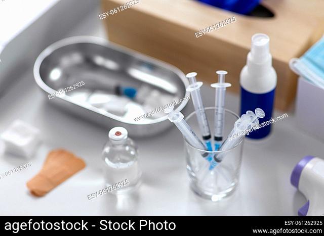 syringes, medicine and other stuff on table