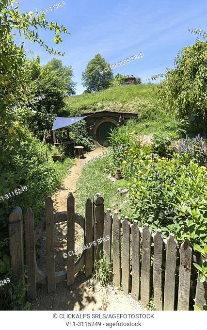Hobbit house with wooden gate and fence. Hobbiton Movie Set, Matamata, Waikato region, North Island, New Zealand