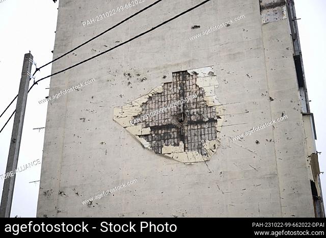 20 October 2023, Ukraine, Irpin: A partially repaired bullet hole can be seen on the side of a multi-story house. The town near Kiev was partially destroyed by...