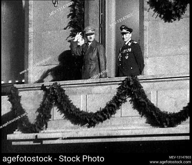 A Close Up of Adolf Hitler, the German Leader, Saluting the Crowd Below With Herman Goering and a German Officer on a Balcony of the Chancellery Which is...