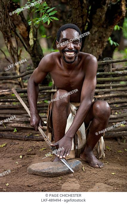 Zulu man sharpening a spear, near Richards Bay, KwaZulu-Natal, South Africa