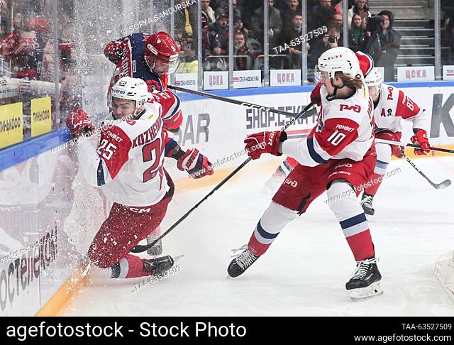 RUSSIA, MOSCOW - OCTOBER 19, 2023: Lokomotiv's Alexei Kozhevnikov and Georgy Ivanov (L-R front) fight for the puck in a 2023/24 KHL Regular Season ice hockey...