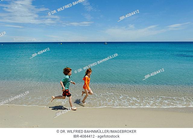 Children running on the beach, Favone, east coast, Corsica, France