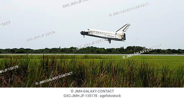 Space Shuttle Discovery, with commander Steven W. Lindsey at the helm, approaches runway 15 at Kennedy Space Center's Shuttle Landing Facility at 9:14 a