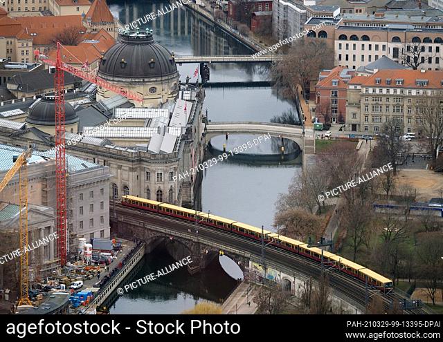 23 March 2021, Berlin: View from the TV tower at Alexanderplatz to the city center with the river Spree at the Museum Island, the Bode Museum (l)