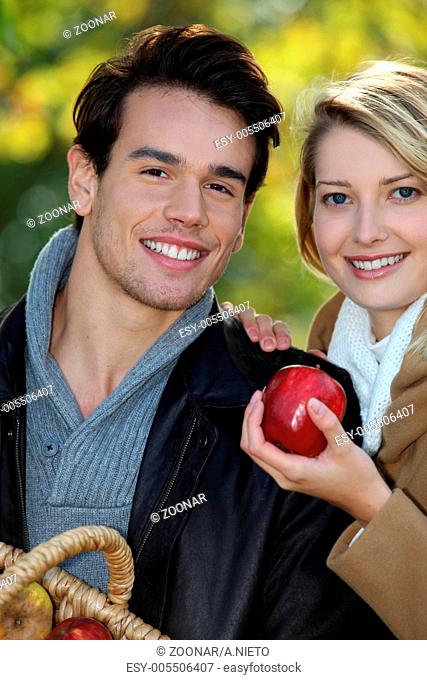 Couple out picking apples