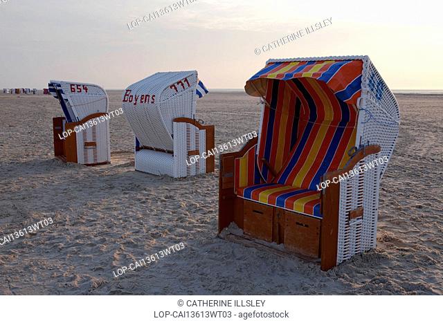 Germany, Schleswig Holstein, Island of Amrum. Traditional beach loungers standing on the beach