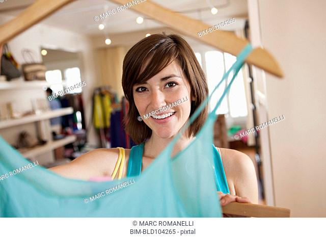 Hispanic woman shopping in clothing store