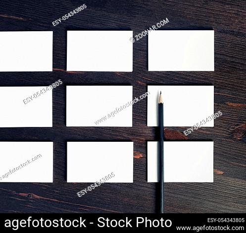 Many blank white business cards and pencil. Flat lay