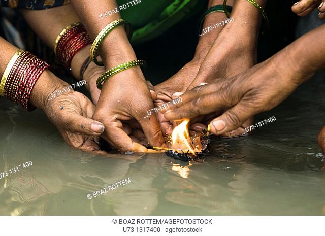 Women perform a puja ceremony at the Ganges river