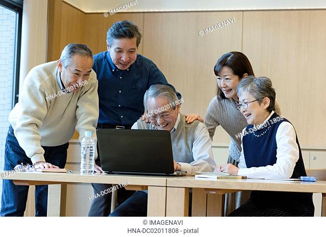 Senior people enjoying using PC
