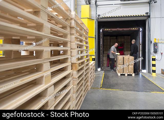 Workers unload boxes with medical protective equipment in storage facility in Opocinek, near Pardubice, Czech Republic, on June 15, 2020
