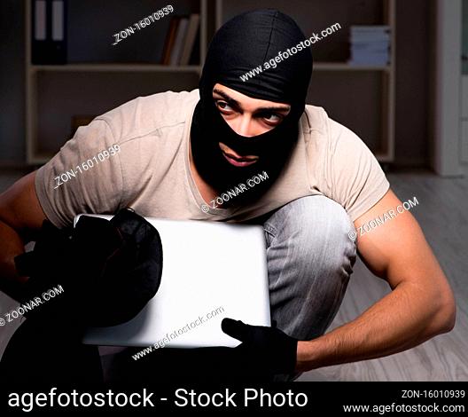 The burglar wearing balaclava mask at crime scene