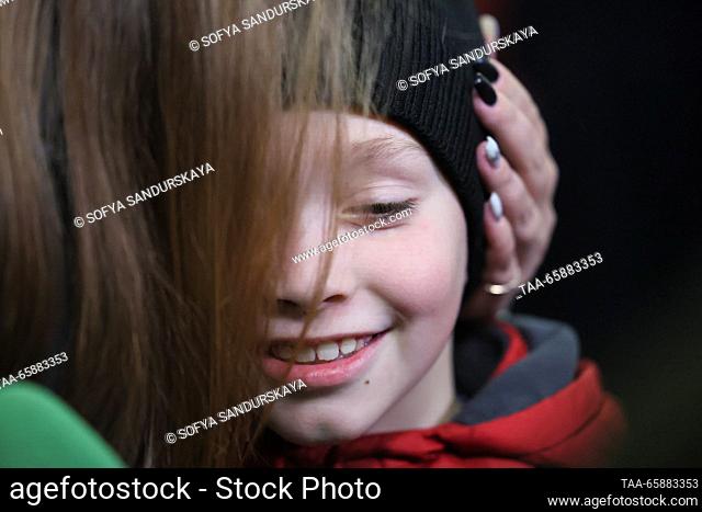 RUSSIA, MOSCOW - DECEMBER 19, 2023: Nikita Artemichev who has arrived on an Istanbul-Moscow flight, is seen with his mother Alexandra Zhulina at Vnukovo...