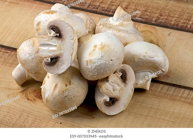 Heap of Perfect Raw Champignons closeup on Wooden background