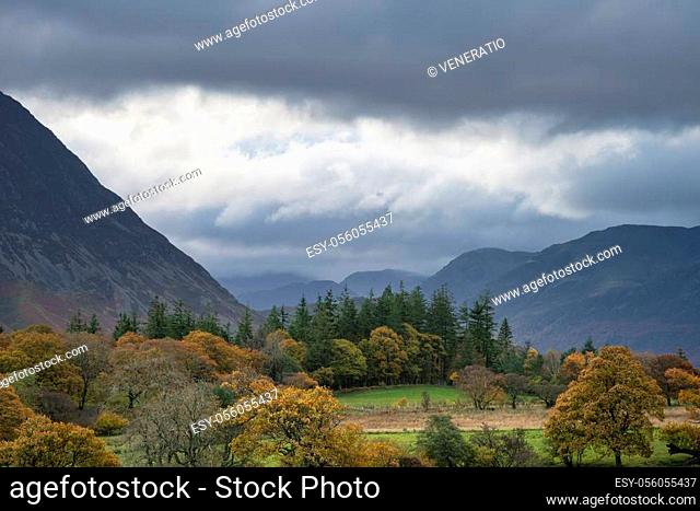 Stunning Autumn Fall landscape view along valley towards Mellbreak and Grasmoor in Lake District with beautiful epic lighting in late afternoon